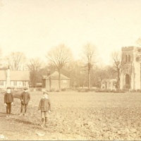 old photo of the church across fields